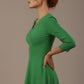 Woman wearing a green dress against a plain background (Jelly Bean Green)