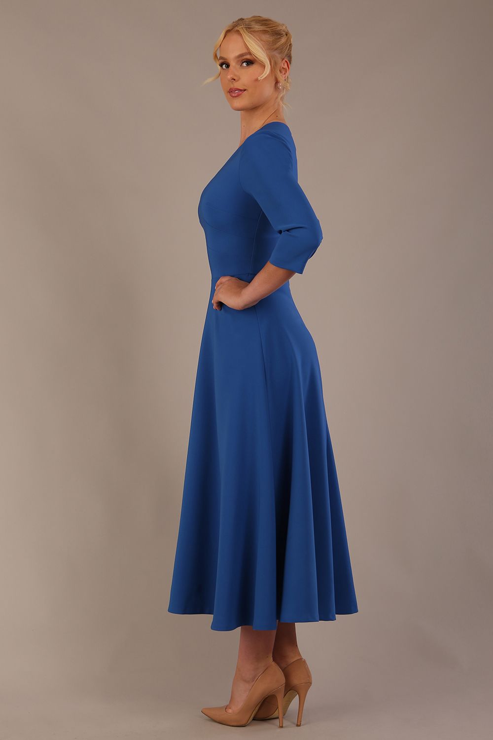  Model wearing the Nova V-neck A-line midaxi dress in vibrant imperial blue side view