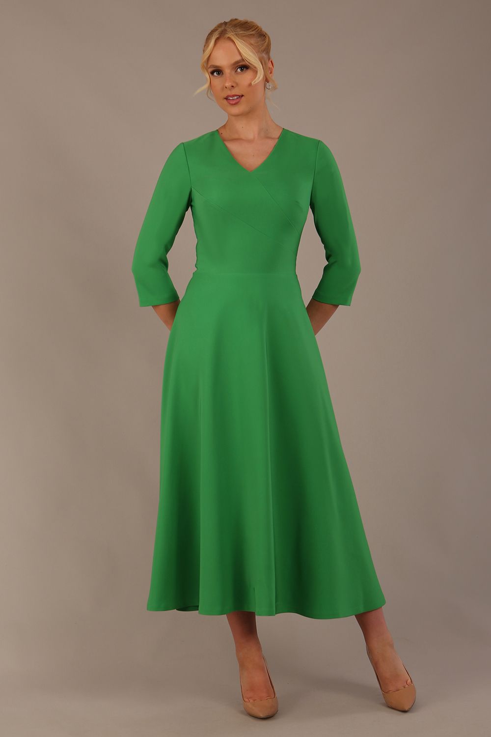  Model wearing the Nova V-neck A-line midaxi dress in vibrant jelly bean green