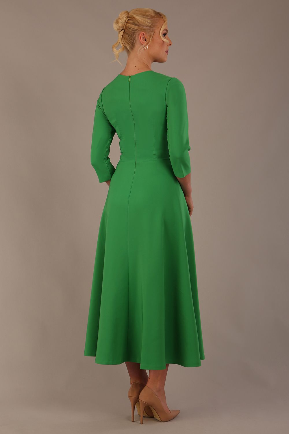  Model wearing the Nova V-neck A-line midaxi dress in vibrant jelly bean green back view