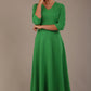  Model wearing the Nova V-neck A-line midaxi dress in vibrant jelly bean green