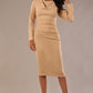 Model wearing the Cassidy cowl neck pencil dress in cafe au lait cream.