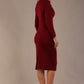 Model wearing the Cassidy cowl neck pencil dress in claret red back view.