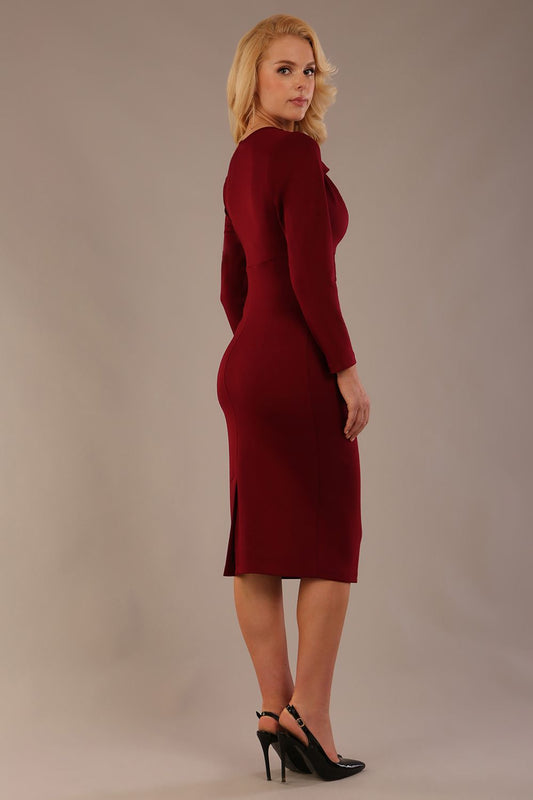 Model wearing the Cassidy cowl neck pencil dress in claret red back view.