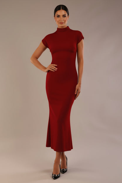 Model wearing the Kaden high neck midaxi dress in claret red, showing the sleek silhouette and cap sleeves against a plain background