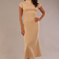 Model wearing the Kaden high neck midaxi dress in cafe au lait cream, showing the sleek silhouette and cap sleeves. against a plain background