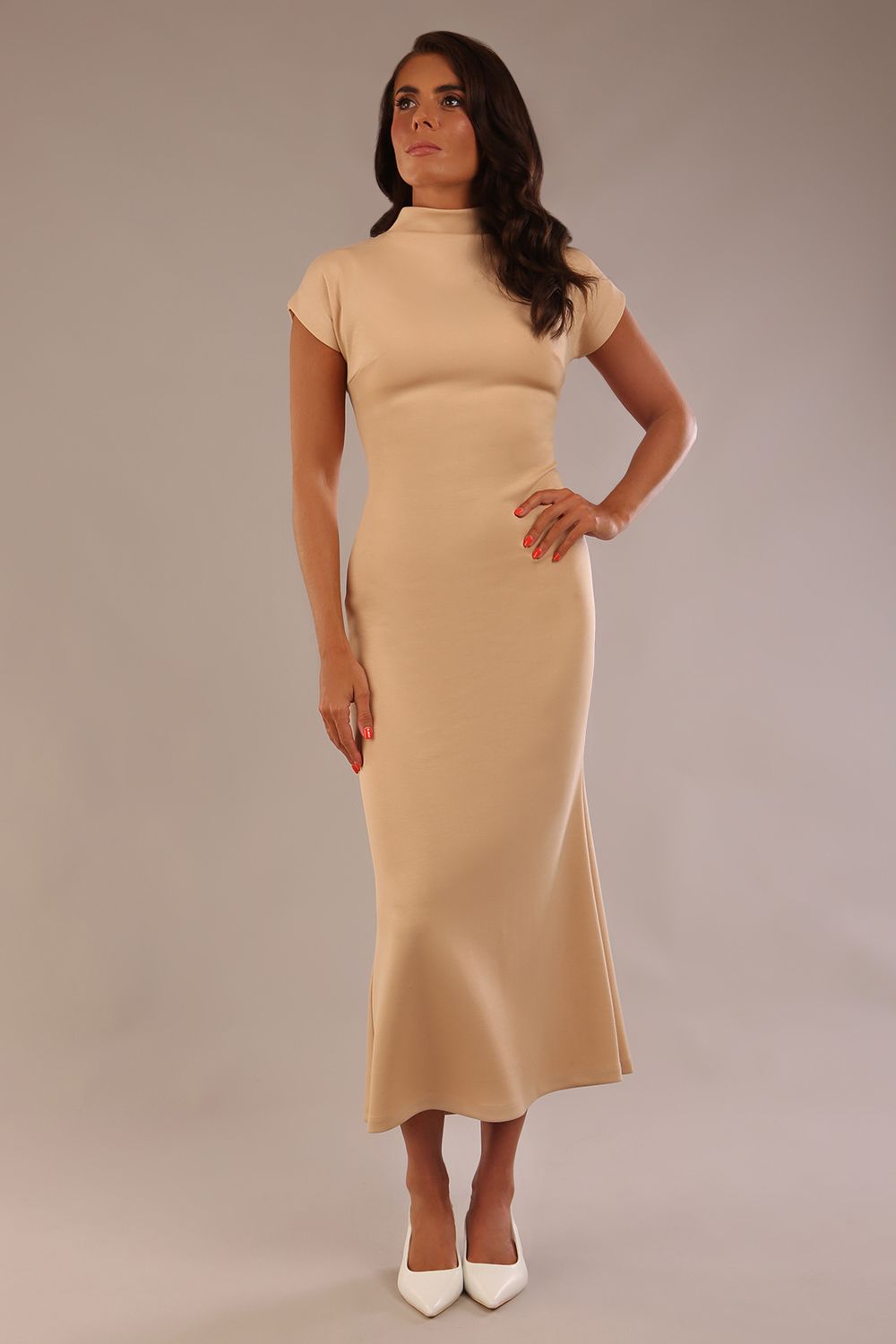 Model wearing the Kaden high neck midaxi dress in cafe au lait cream, showing the sleek silhouette and cap sleeves. against a plain background