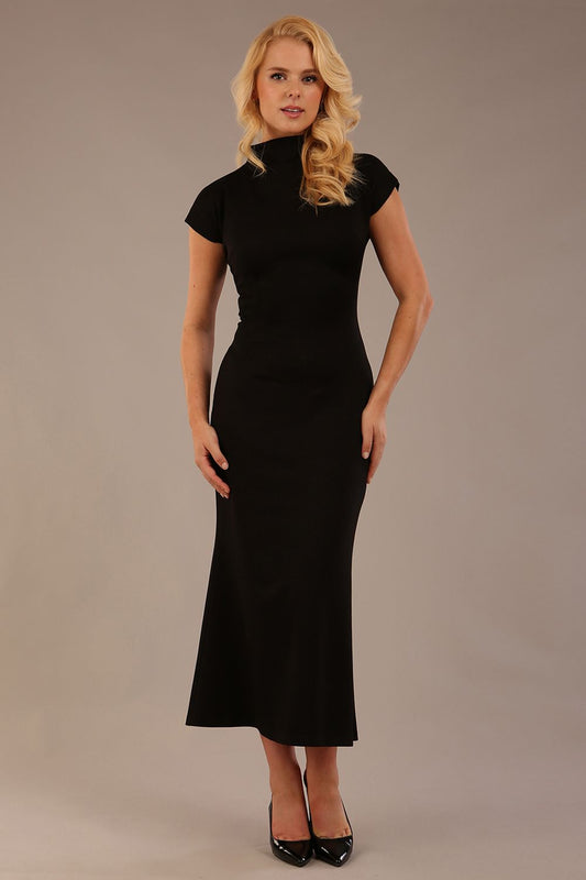 Model wearing the Kaden high neck midaxi dress in jet black, showing the sleek silhouette and cap sleeves. against a plain background