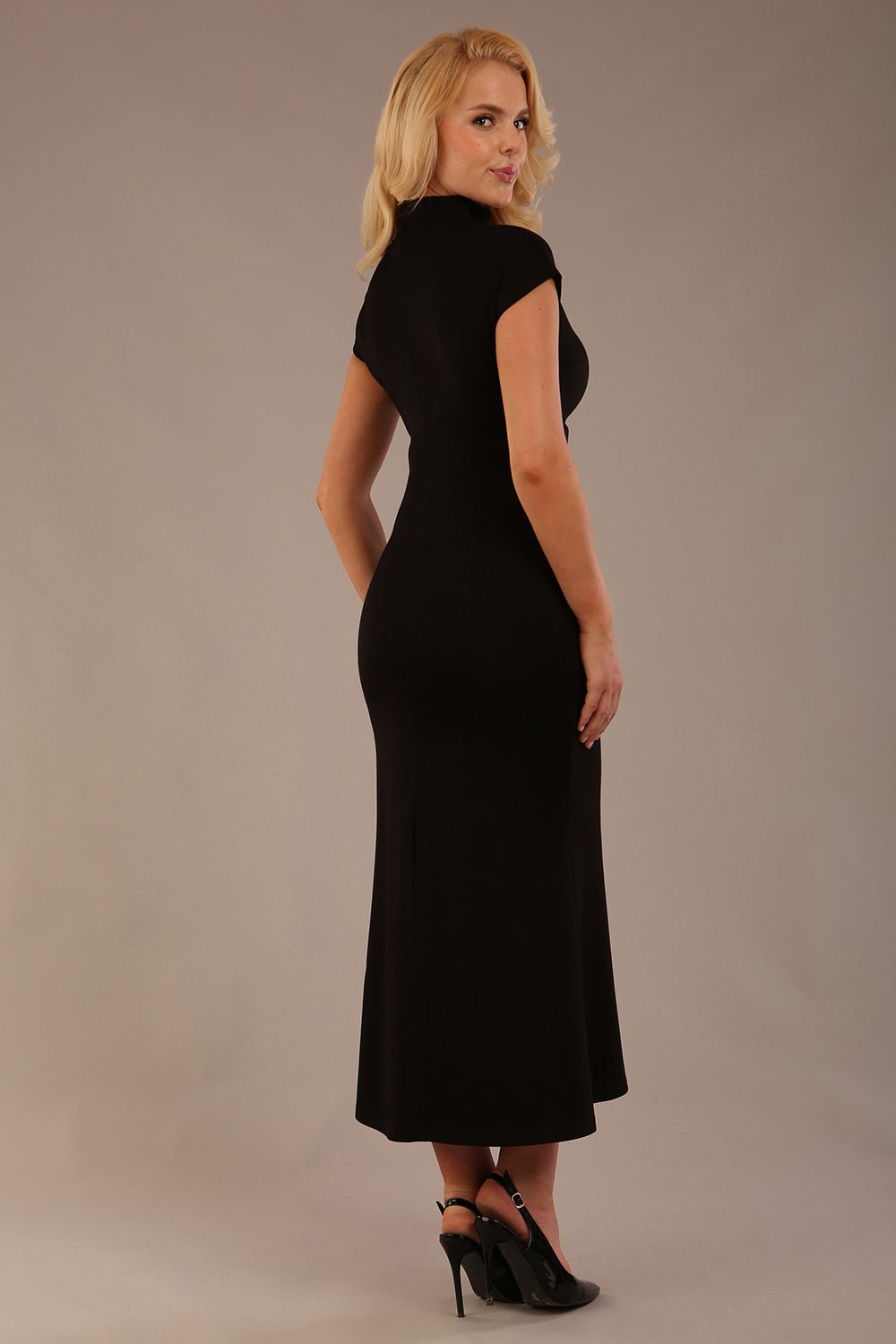 Model wearing the Kaden high neck midaxi dress in jet black, showing the sleek silhouette and cap sleeves against a plain background back view
