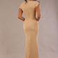 Model wearing the Kaden high neck midaxi dress in cafe au lait cream, showing the sleek silhouette and cap sleeves. against a plain background back view