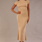 Model wearing the Kaden high neck midaxi dress in cafe au lait cream, showing the sleek silhouette and cap sleeves. against a plain background