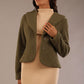 Model wearing the Teddy Luxe Boucle Jacket in oive green, styled over a cream pencil dress close up