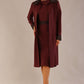  Model wearing the Haven lace trim midi coat in port royale for a sophisticated co-ord look.