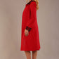 Side view of the Haven coat in salsa red, showing the lace cuff detail and the fluid drape of the couture fabric.