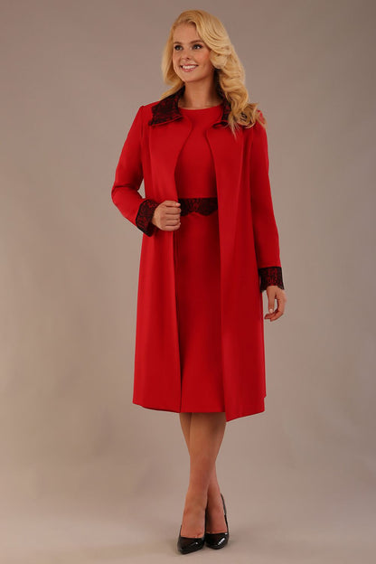 Model wearing the Haven lace trim midi coat in salsa red, styled with the matching Lovell dress.