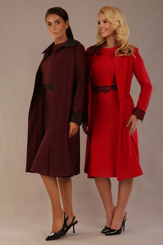 Two women wearing matching outfits with a brown and red color scheme on a plain background- the Haven lace trim midi coat in port royale and salsa red colour