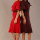 Two models wearing matching a diva catwalk outfits with a port royale and salsa red colour scheme on a plain background.