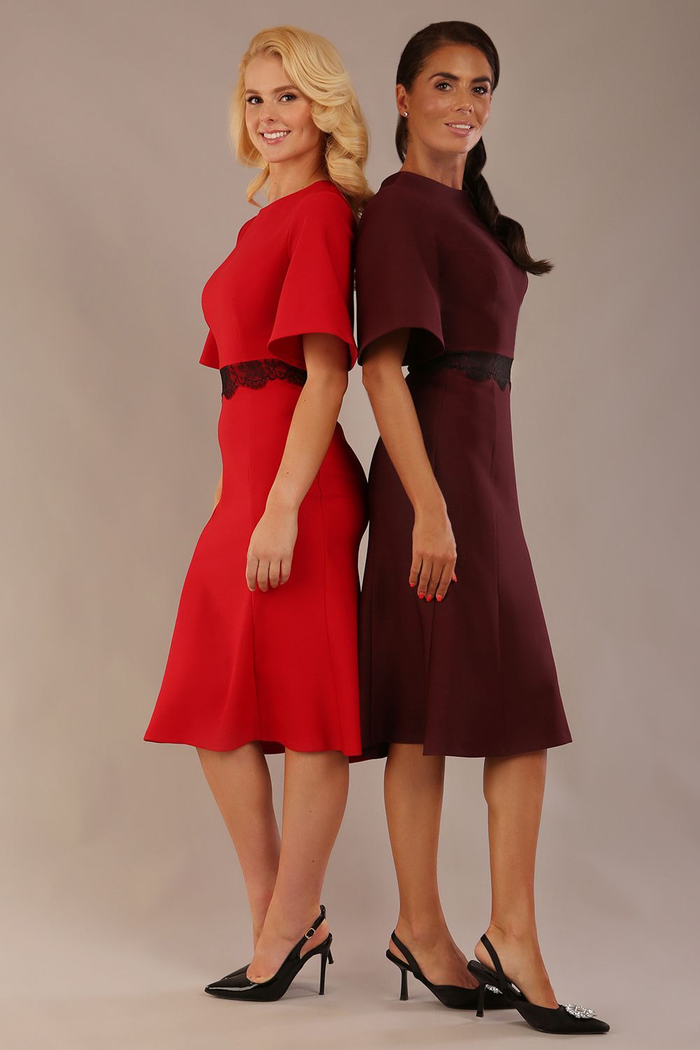 Two models wearing matching a diva catwalk outfits with a port royale and salsa red colour scheme on a plain background.