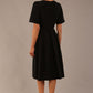Model wearing the Dale pleated A-line dress against a plain background (Black)