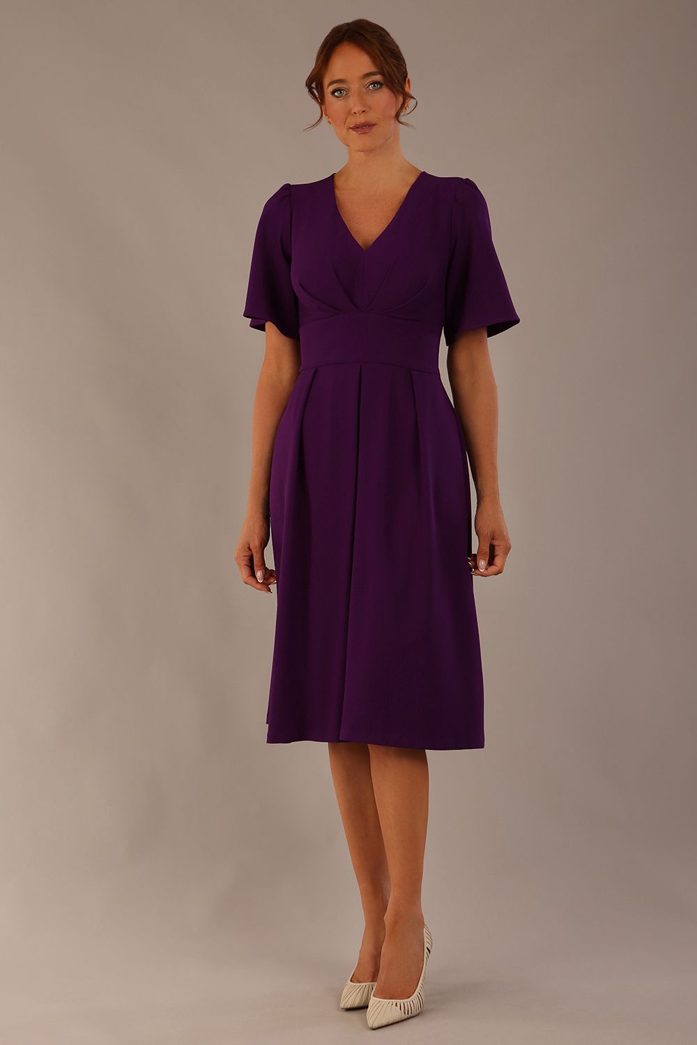 Model wearing the Dale pleated A-line dress against a plain background (Purple)