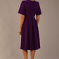 Model wearing the Dale pleated A-line dress against a plain background (Purple)