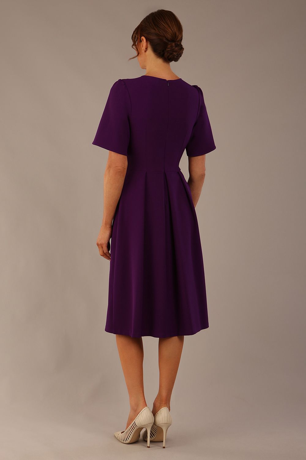 Model wearing the Dale pleated A-line dress against a plain background (Purple)