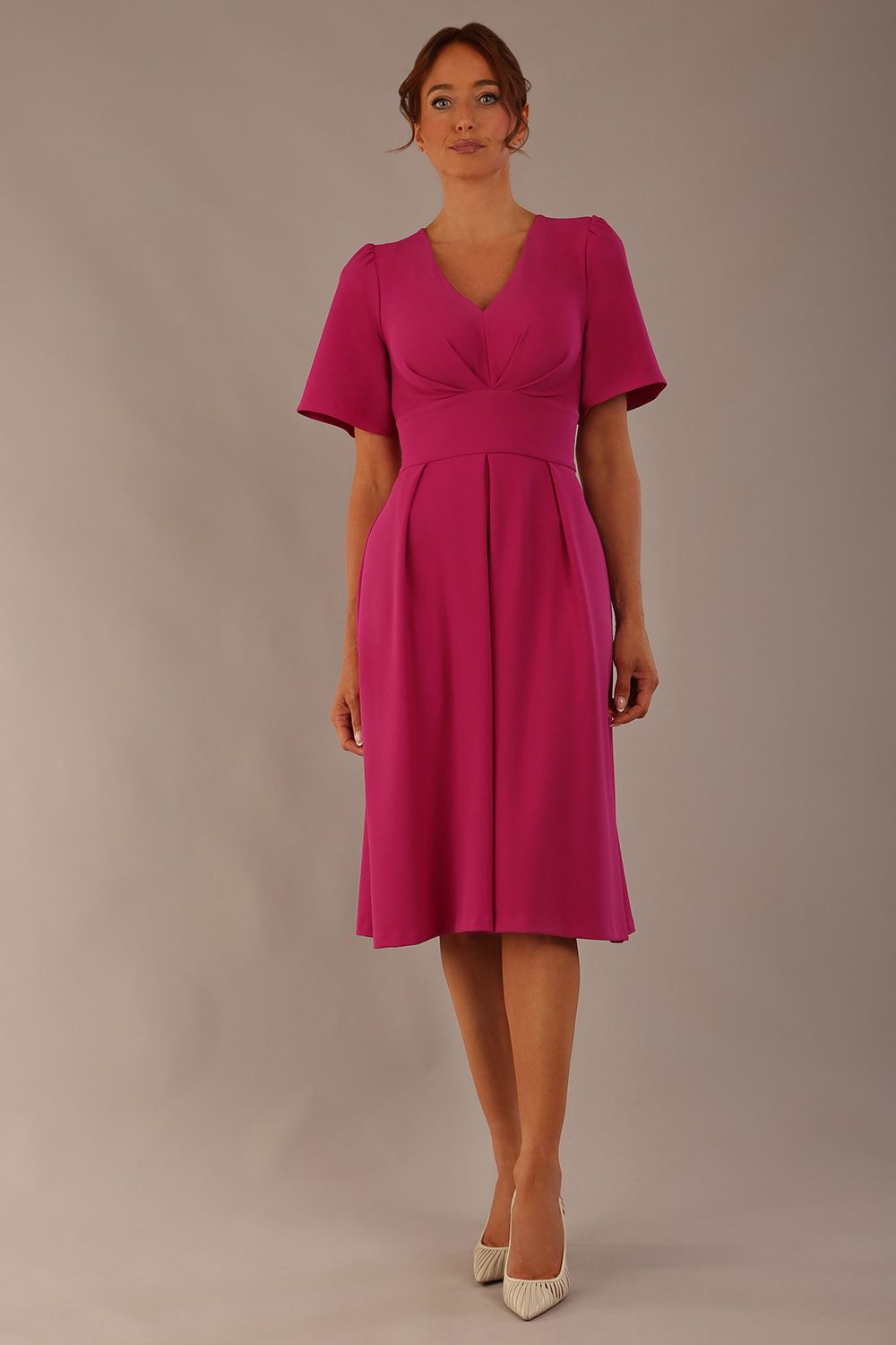 Model wearing the Dale pleated A-line dress against a plain background (Magenta)