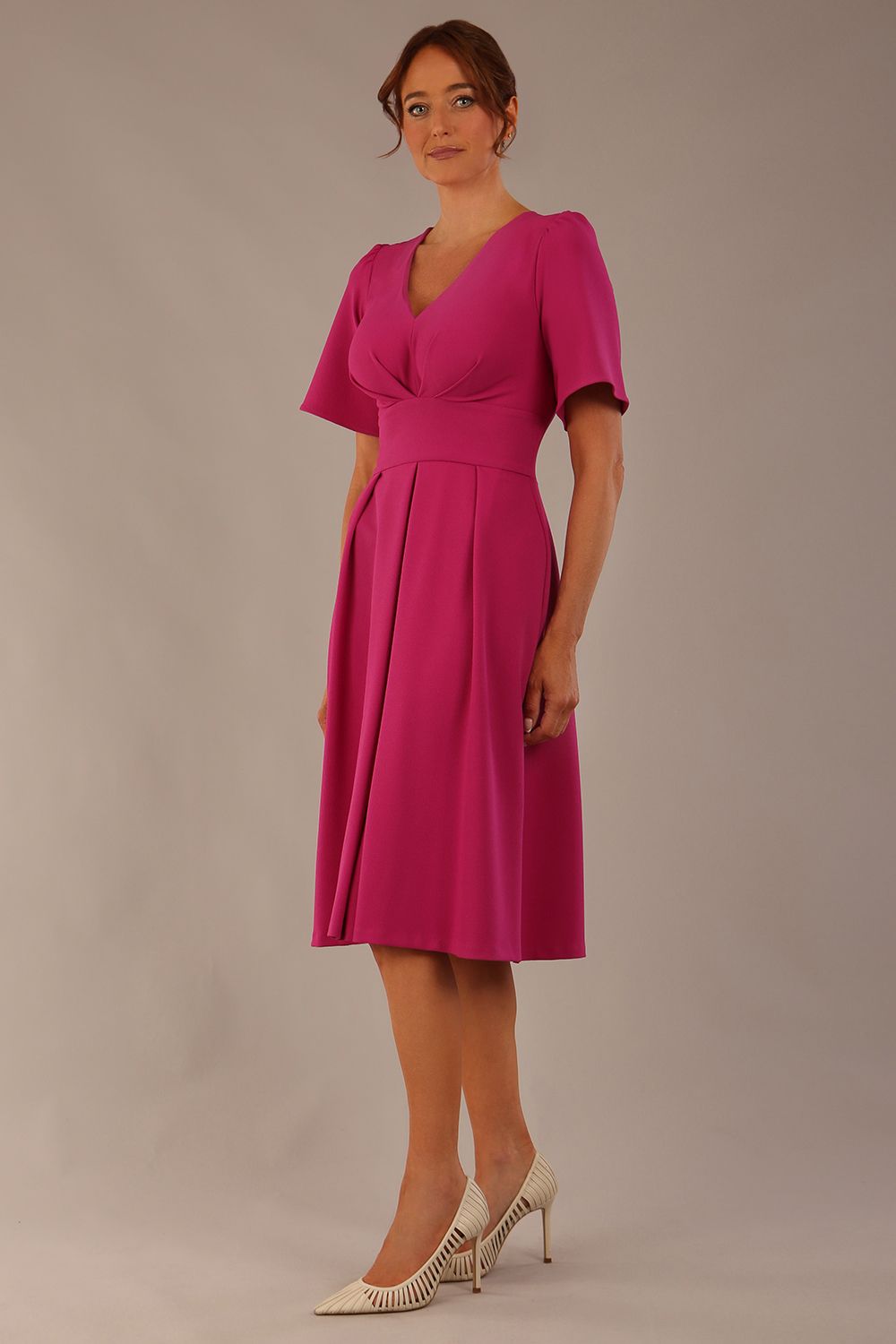 Model wearing the Dale pleated A-line dress against a plain background (Magenta)