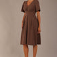 Model wearing the Dale pleated A-line dress against a plain background (Peppercorn Brown)