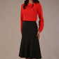 Model wearing a black Marlene fishtail skirt with a sophisticated top.