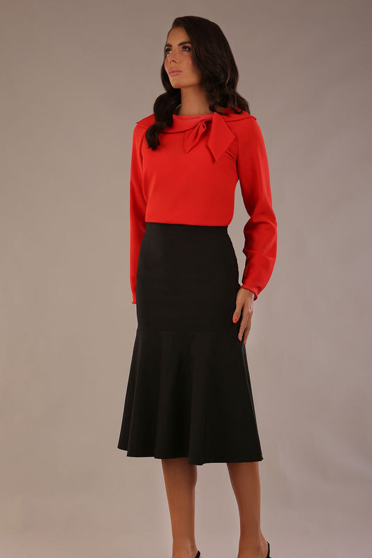 Model wearing a black Marlene fishtail skirt with a sophisticated top.