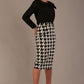 Woman wearing a divacatwalk cressida black top and houndstooth patterned skirt against a plain background