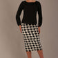 Woman wearing a diva catwalk cressida black top and houndstooth skirt against a neutral background