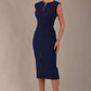 Model wearing the Wesley notched pencil dress in navy blue, showcasing the sculpted silhouette and V-notch neckline