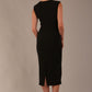 Model wearing the Wesley notched pencil dress in black, showcasing the sculpted silhouette and V-notch neckline back view