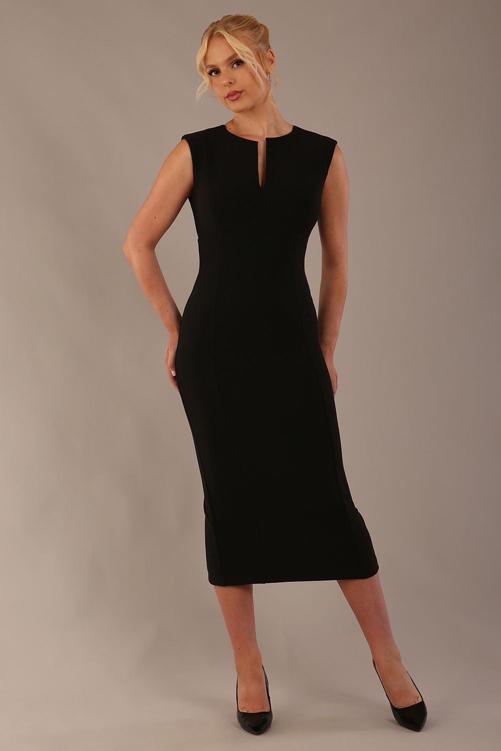 Model wearing the Wesley notched pencil dress in black, showcasing the sculpted silhouette and V-notch neckline