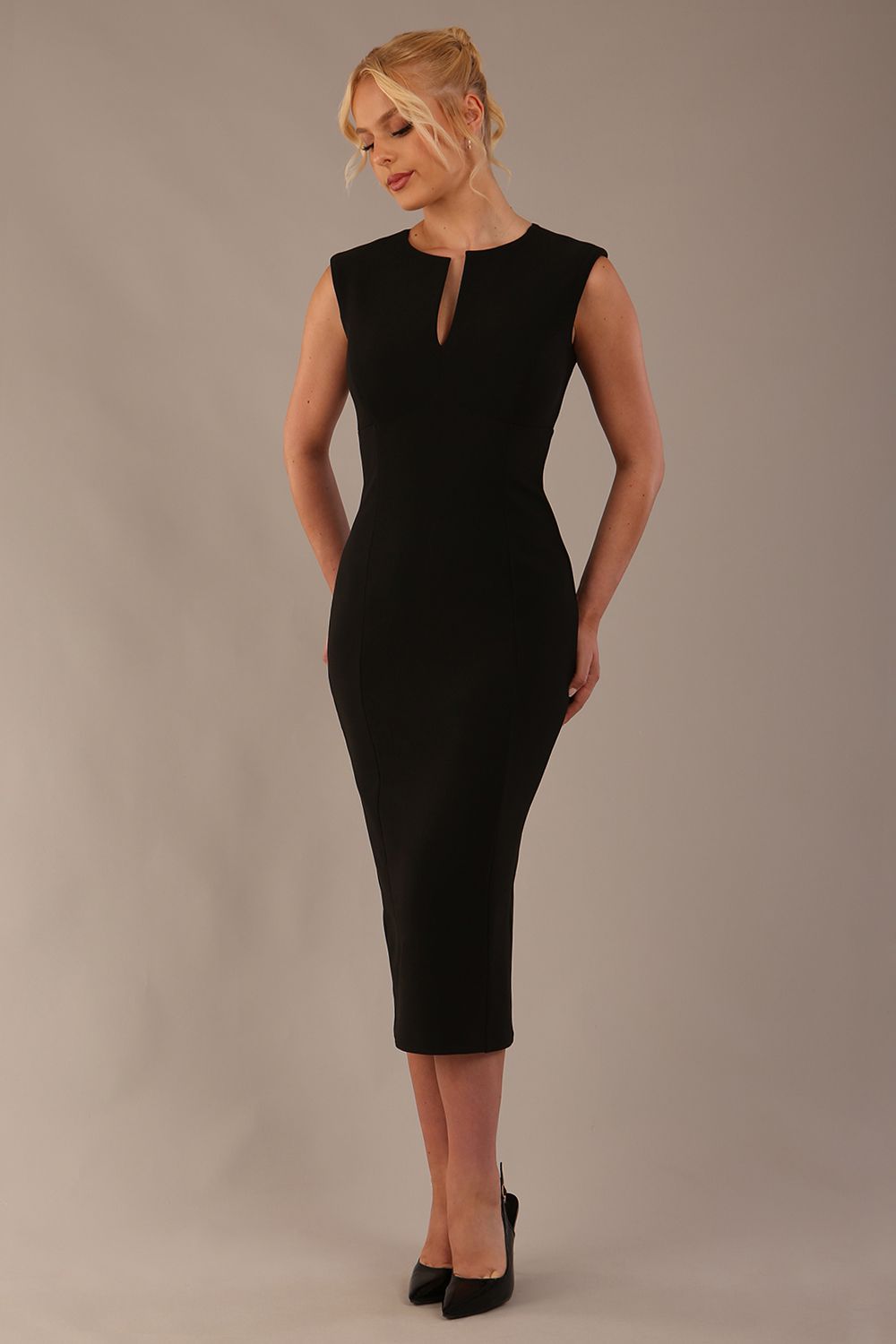 Model wearing the Wesley notched pencil dress in black, showcasing the sculpted silhouette and V-notch neckline