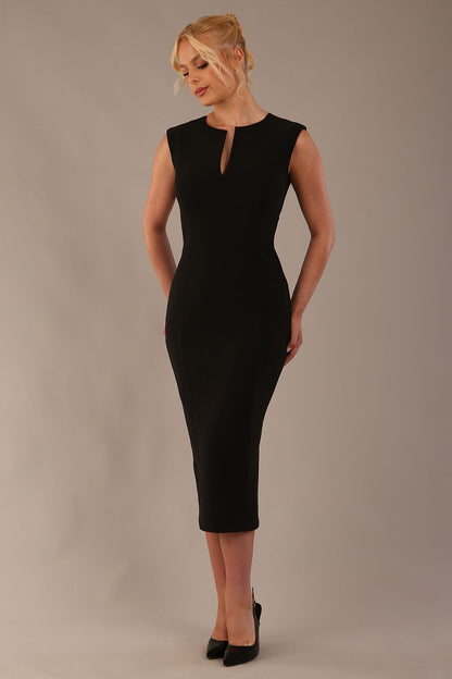 Model wearing the Wesley notched pencil dress in black, showcasing the sculpted silhouette and V-notch neckline