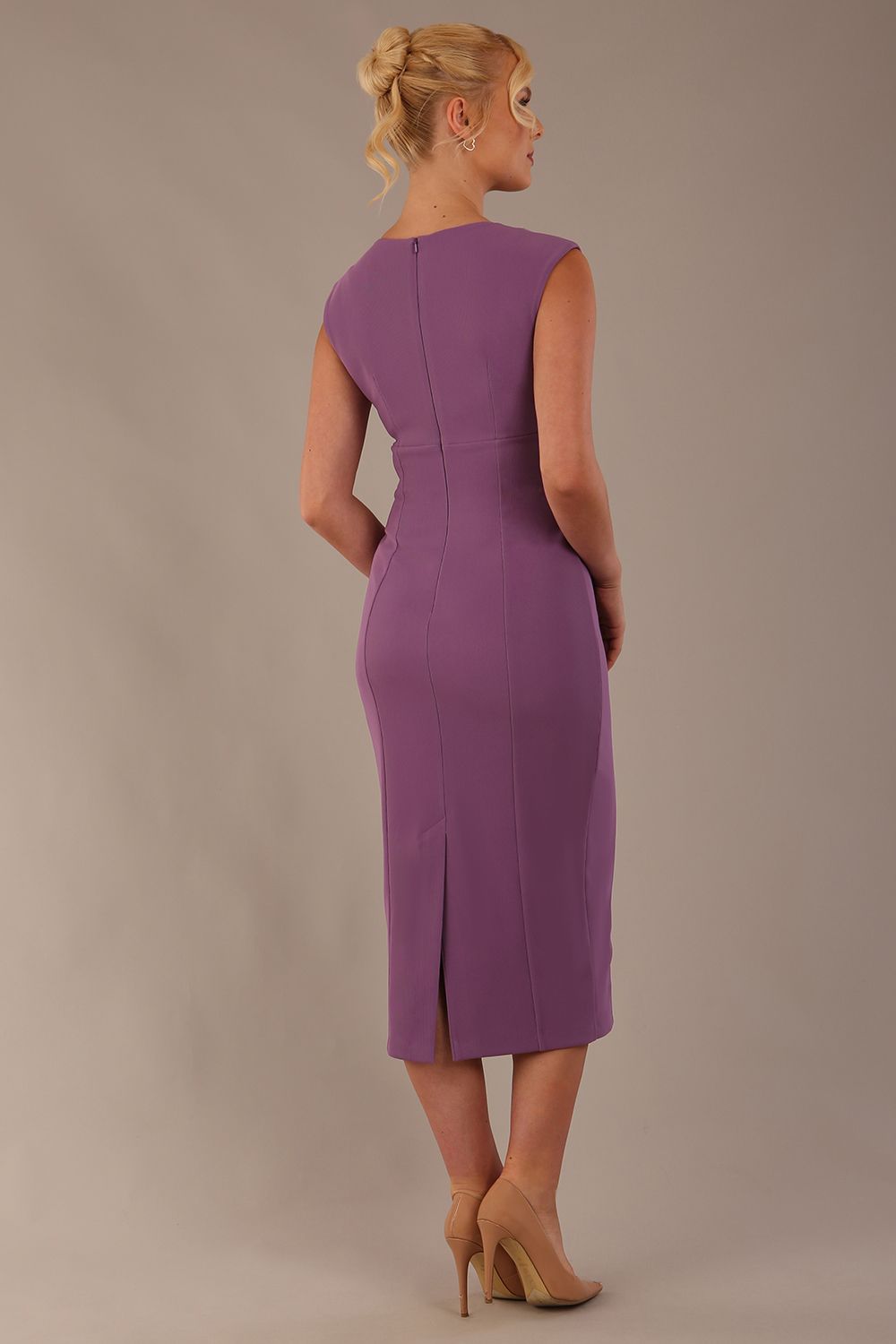 Model wearing the Wesley notched pencil dress in purple heart, showcasing the sculpted silhouette and V-notch neckline back view