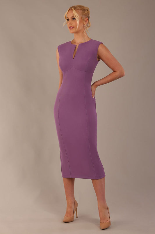 Model wearing the Wesley notched pencil dress in Purple heart, showcasing the sculpted silhouette and V-notch neckline