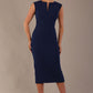 Model wearing the Wesley notched pencil dress in navy blue, showcasing the sculpted silhouette and V-notch neckline