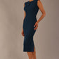 Model wearing the Wesley notched pencil dress in teal, showcasing the sculpted silhouette and V-notch neckline side view