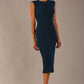Model wearing the Wesley notched pencil dress in teal, showcasing the sculpted silhouette and V-notch neckline side view