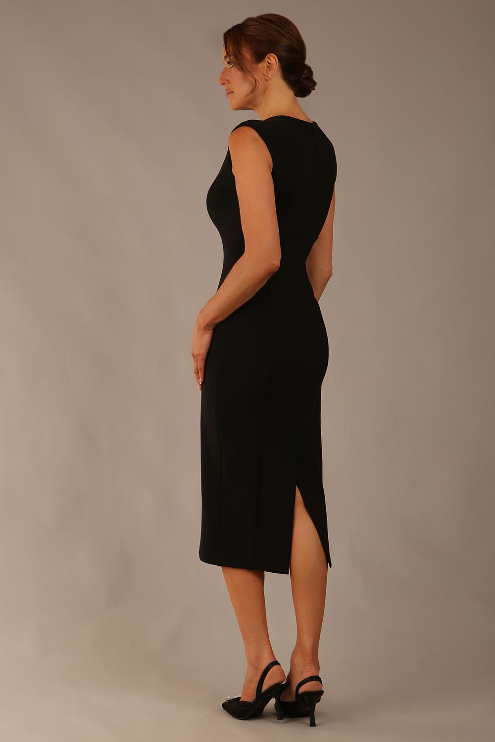 Model wearing the Wesley notched pencil dress in black, showcasing the sculpted silhouette and V-notch neckline back view