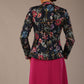 The Keanu floral jacket layered over a pink A-line dress for an elegant occasion look, back view (Nightshade Bloom)