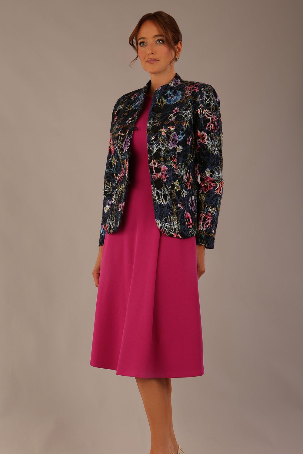 The Keanu floral jacket layered over a pink A-line dress for an elegant occasion look (Nightshade Bloom)
