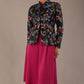 The Keanu floral jacket layered over a pink A-line dress for an elegant occasion look (Nightshade Bloom)