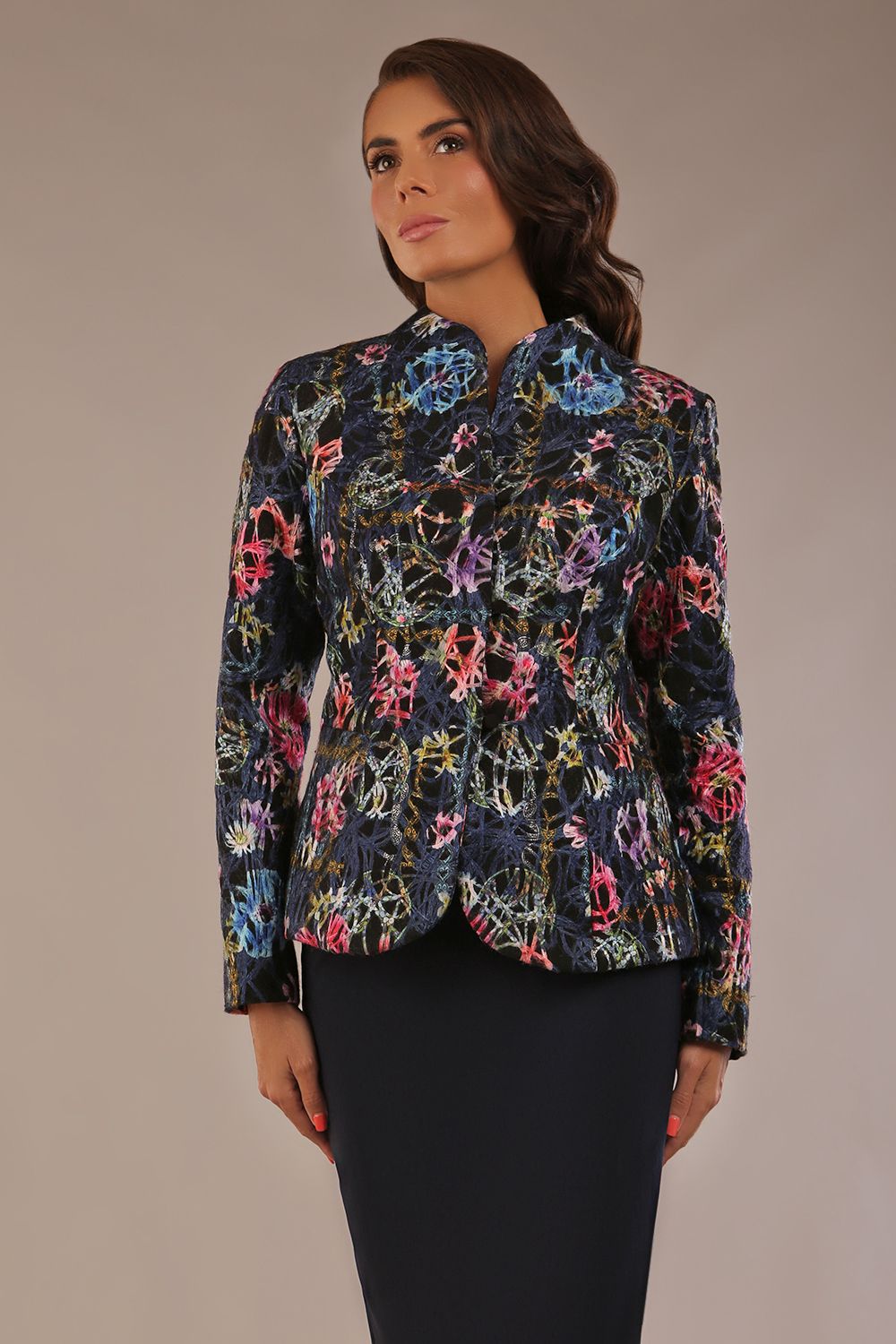 Model wearing the Keanu high-neck floral jacquard jacket styled with a navy pencil skirt (Nightshade Bloom)