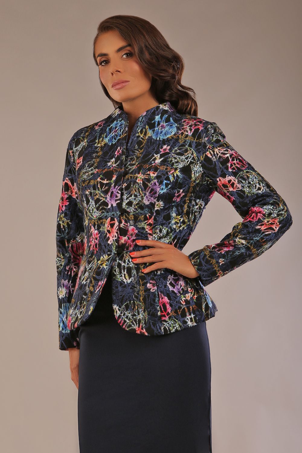 Model wearing the Keanu high-neck floral jacquard jacket styled with a navy pencil skirt (Nightshade Bloom)