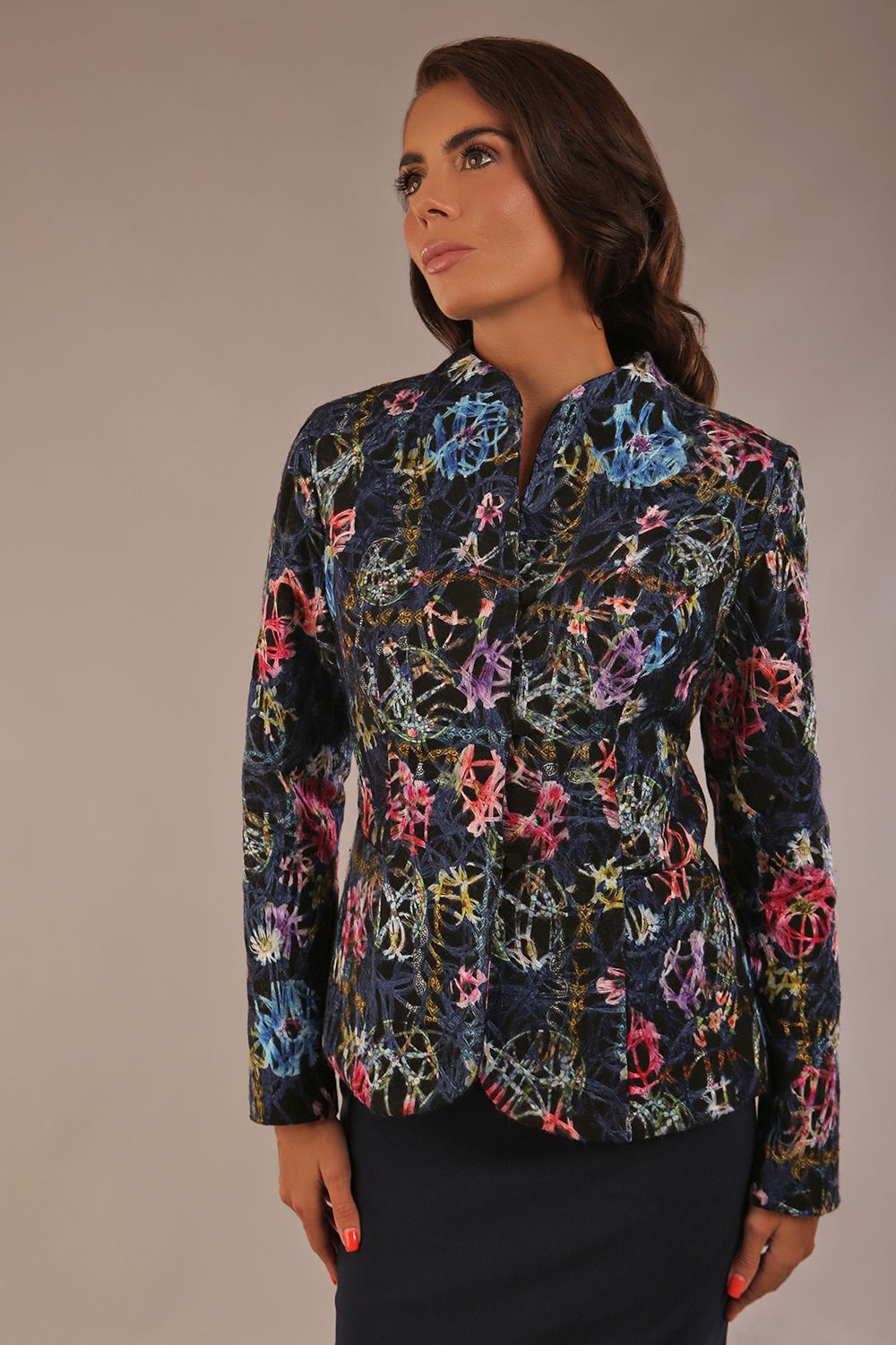 Model wearing the Keanu high-neck floral jacquard jacket styled with a navy pencil skirt (Nightshade Bloom)